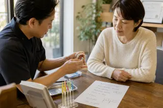 Dentist showing a dental cleaning technique to an attentive patient at a sunlit wooden table in a welcoming dental office, both absorbed in the demonstration.